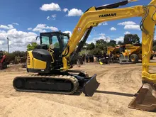 Construction equipment positioned on-site, used for installing safety barriers and supporting infrastructure development.