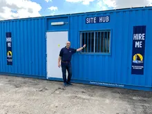 Man standing in front of blue Site Hub shipping container.
